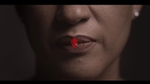 An image of a microphone with a line through it – the symbol for mute on calls – covers a womans lips