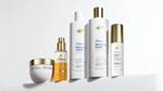 Five products from the Dove Damage Therapy range, designed to repair and strengthen damaged hair. Packaging is white with gold accents.
