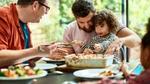 Young child with male guardians eating a plant-based meal