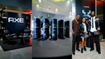 A lounge-style AXE brand experience featuring black seating, ambient lighting, and product displays in a modern indoor setting.