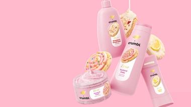 An image of Dove's Crumbl products including Strawberry Crumb Cake, Confetti Cake and Lemon Glaze on a pink background.