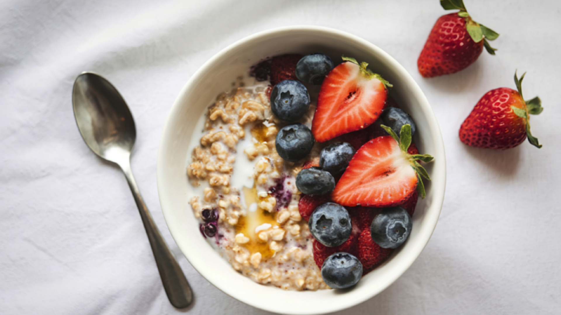 A bowl of oats and red berries.