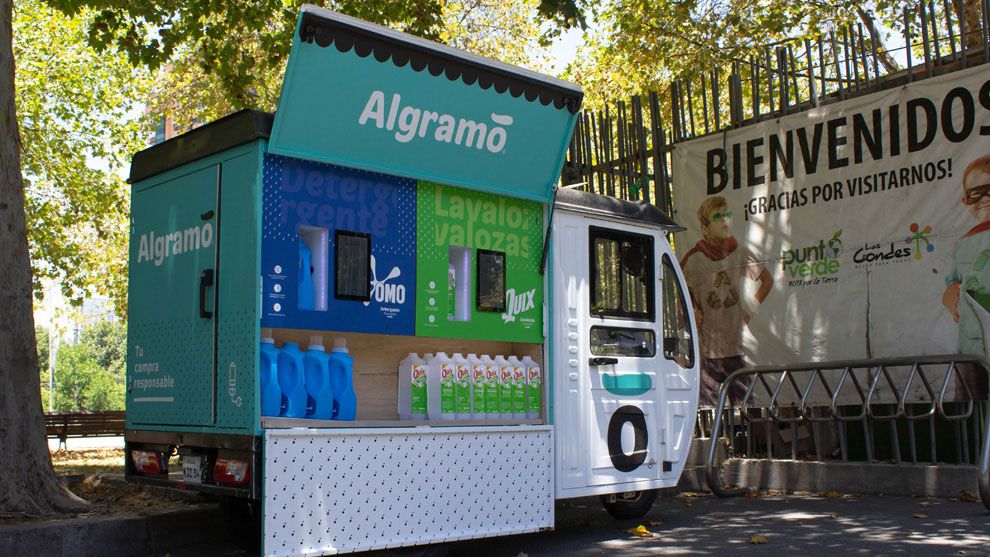 Quix and Omo bottles with a Algramo van in the background.
