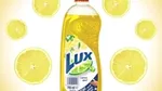 Advert showing a bottle of Lux hand dishwash with a background pattern of slices of lemon.