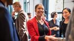 Businesswoman shaking hands. In 2020, Unilever reached its target of 50% of all managerial roles being held by women.