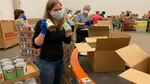 A photo of Unilever employees packing boxes for the United for America initiative