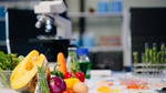 Food items on a counter with a microscope in the background.
